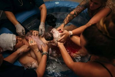 woman delivering twins in water