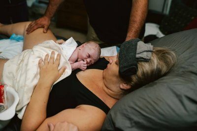 woman holding baby after birth
