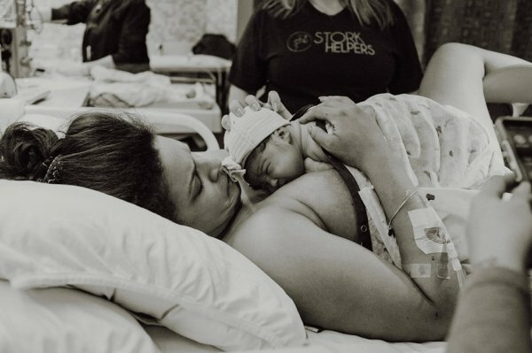 black and white photo of woman holding baby