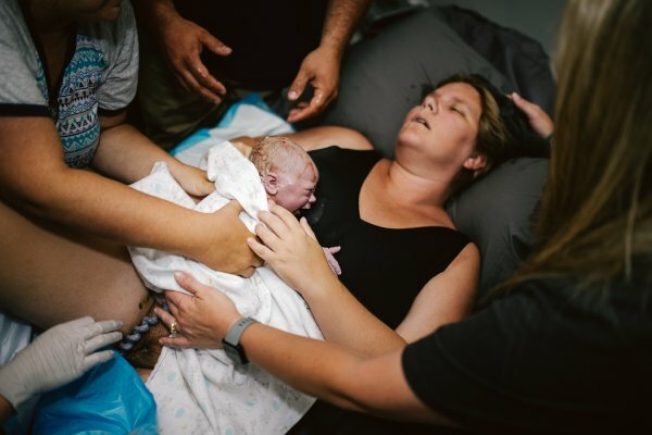 Woman holding her baby after just giving birth