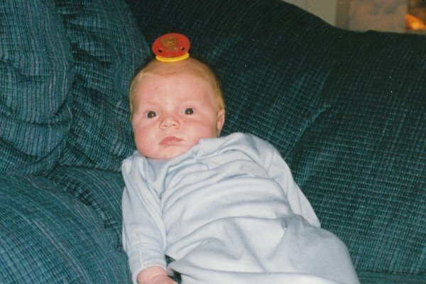 baby with binky of his head