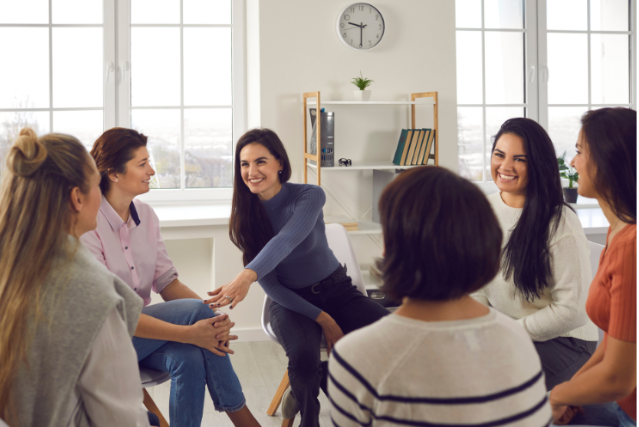 a group of women sitting in a circle talking