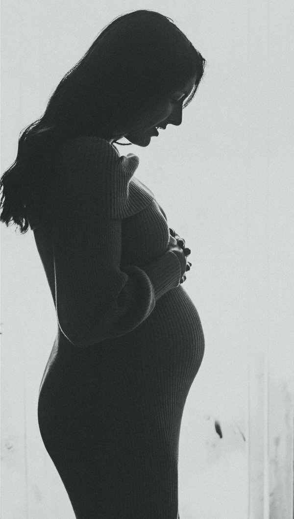 woman looking at belly silhouette