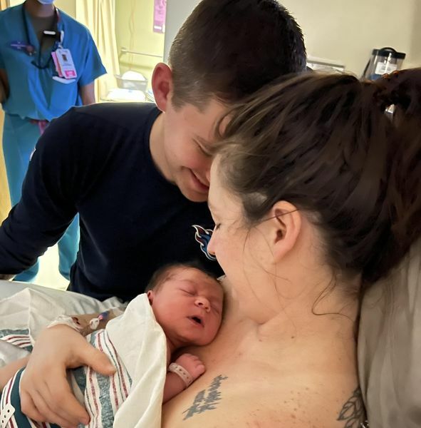 couple looking at newborn baby