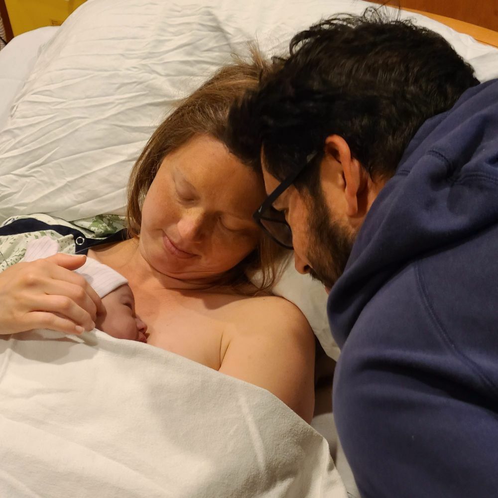 couple looking at newborn baby